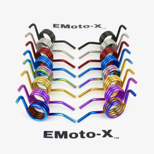 Two rows of eMoto-x racing titanium peg springs sets for Surron Ultra Bee at angles   in a variety of colors on white background with two black letter emoto-x logos